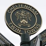 Close up view of the top of Cheltenham's twinning signpost